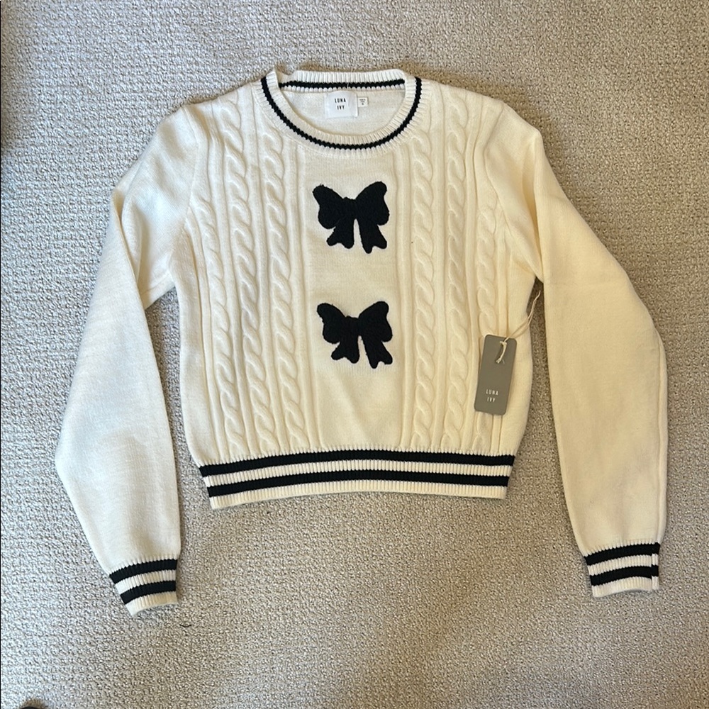 Chic Cream and Black Sweater with Bow Accents